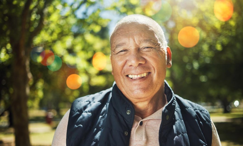 Senior man in a park, out for a morning walk.